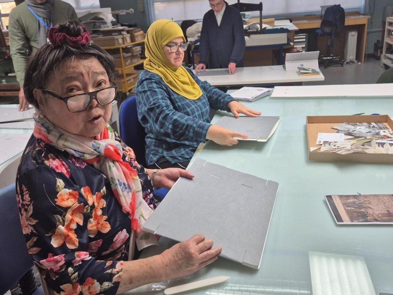 C4W_Conservation for Wellbeing participants sewing a pamphlet at The London Archives.jpg 1